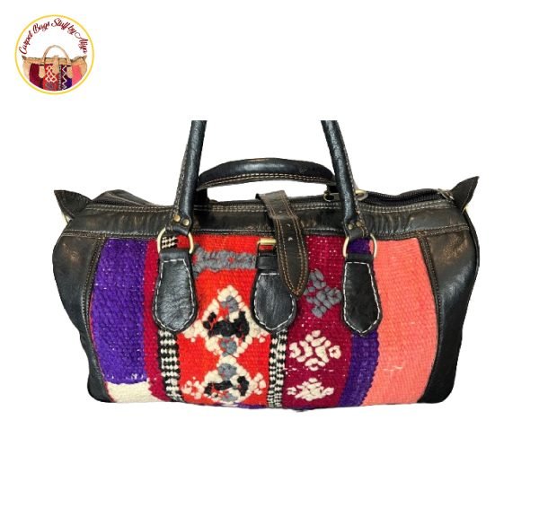 Traditional handmade Hunza carpet bag featuring geometric patterns in shades of blue, red, and white, set against a neutral background.