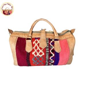 Handcrafted Noel carpet bag with a festive red and green floral design, displayed against a neutral background.